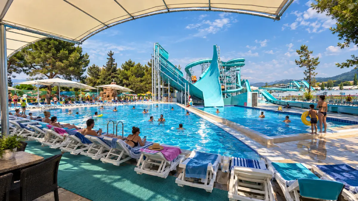 Waterslides and swimming pools at Dolusu Park in Kemer against the Taurus Mountains